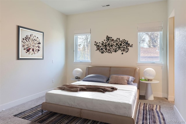 bedroom featuring carpet flooring and multiple windows