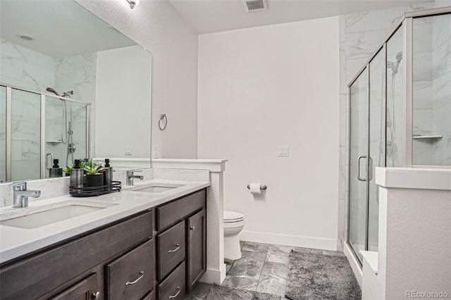 10095 E 59th Ave, Denver, CO 80238 - bathroom featuring marble finish flooring, double vanity, and a marble finish shower