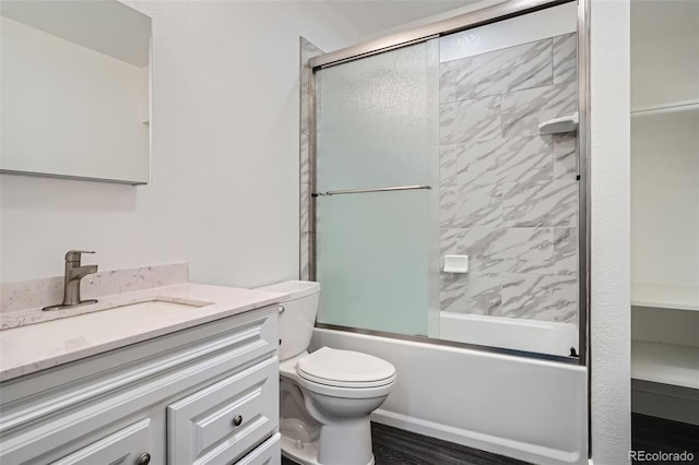 10095 E 59th Ave, Denver, CO 80238 - bathroom featuring vanity, enclosed tub / shower combo, and wood finished floors