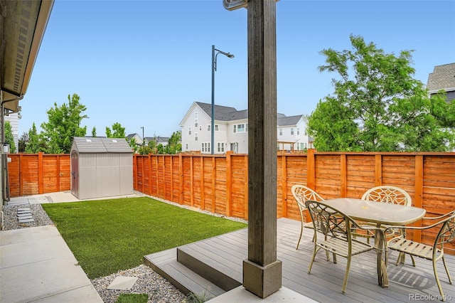 10095 E 59th Ave, Denver, CO 80238 - fenced backyard with outdoor dining space, a storage shed, a deck, and a residential view