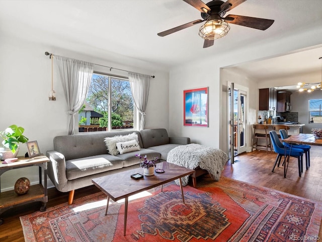 living area with wood finished floors and ceiling fan