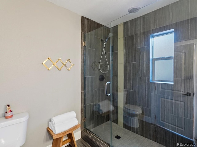 full bathroom featuring toilet and a stall shower