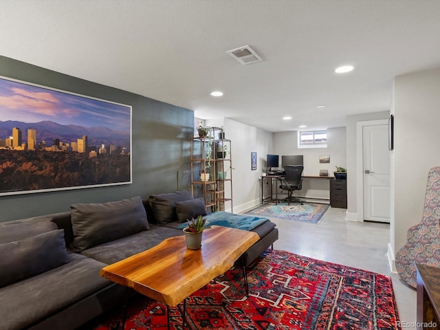 living area with a desk, recessed lighting, finished concrete flooring, and baseboards