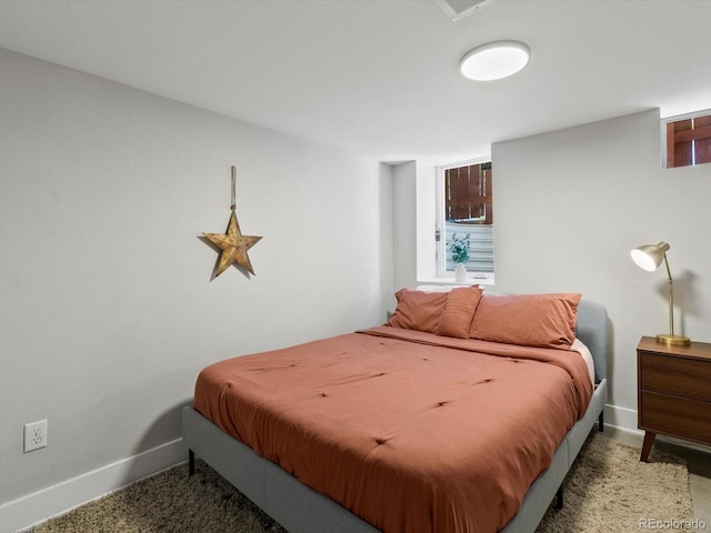 bedroom with baseboards and carpet flooring