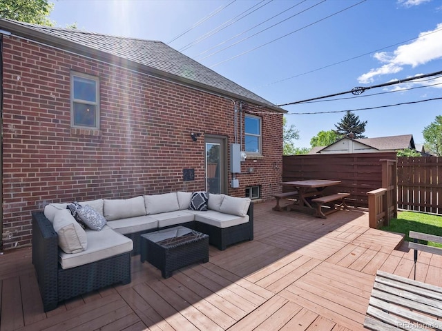 deck with an outdoor living space, outdoor dining space, and fence