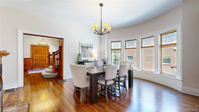 dining space with plenty of natural light and dark wood-type flooring