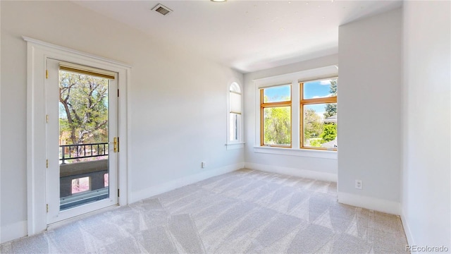 empty room featuring a healthy amount of sunlight and carpet floors