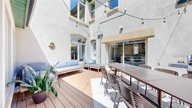 wooden terrace with an outdoor hangout area