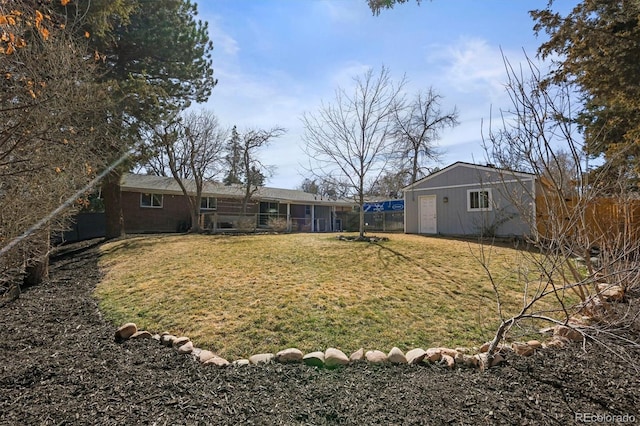 view of yard with an outdoor structure and fence