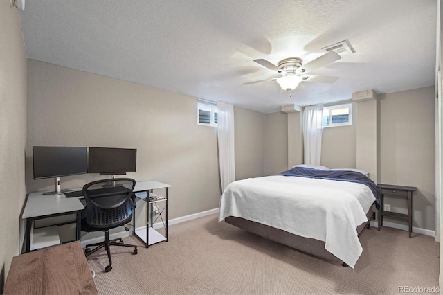 bedroom with visible vents, baseboards, a textured ceiling, and carpet flooring