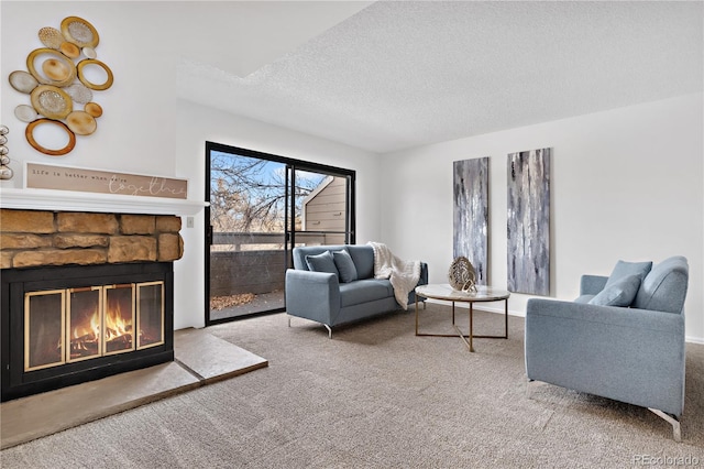 living room with carpet, a fireplace, and a textured ceiling