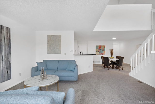 living room with carpet floors and a textured ceiling