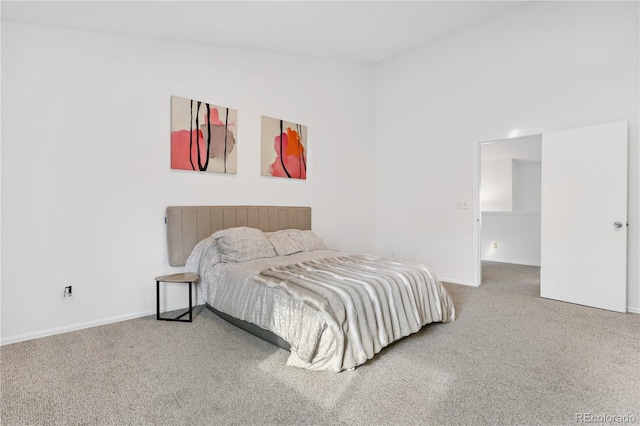 carpeted bedroom with lofted ceiling