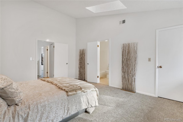 bedroom with high vaulted ceiling, light carpet, and connected bathroom