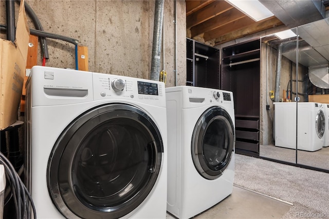 clothes washing area with washing machine and clothes dryer