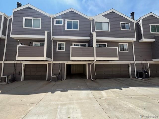 6895 W 84th Way Unit 4, Arvada, CO 80003 - rear view of house with a garage, driveway, and cooling unit