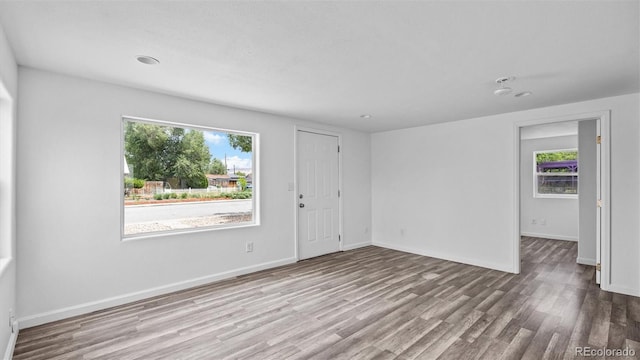 28571/2 Teller Ave, Grand Junction, CO 81501 - empty room with healthy amount of natural light, wood finished floors, and recessed lighting