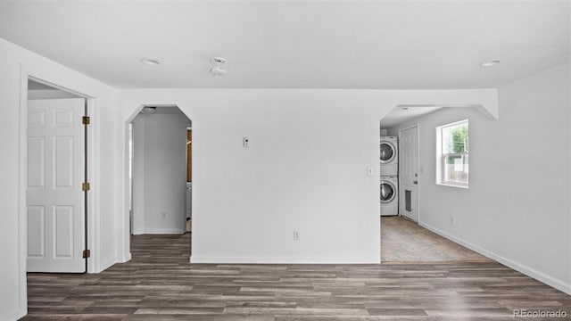 28571/2 Teller Ave, Grand Junction, CO 81501 - unfurnished room featuring stacked washer / dryer, arched walkways, wood finished floors, and recessed lighting
