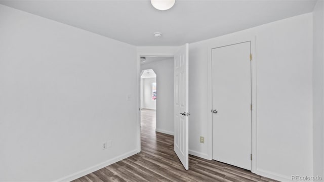 28571/2 Teller Ave, Grand Junction, CO 81501 - unfurnished bedroom with wood finished floors and arched walkways