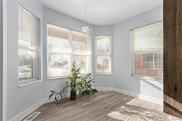 unfurnished dining area with hardwood / wood-style floors