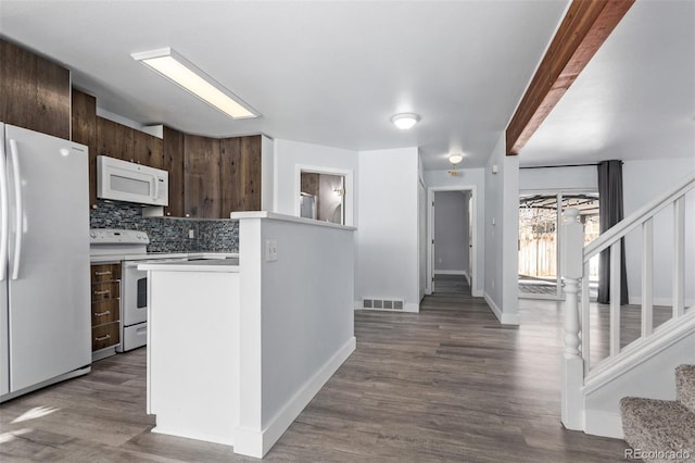 kitchen with dark brown cabinetry, beamed ceiling, backsplash, hardwood / wood-style floors, and white appliances