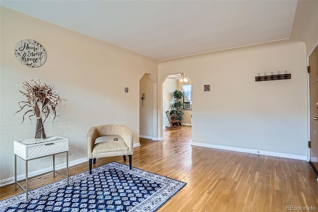 1523 Ivy St Unit 6, Denver, CO 80220 - living area featuring hardwood / wood-style flooring, arched walkways, and a ceiling fan