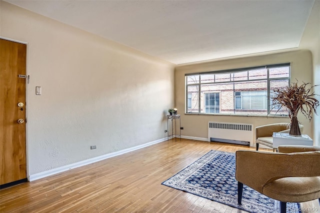 1523 Ivy St Unit 6, Denver, CO 80220 - sitting room featuring radiator heating unit and wood finished floors