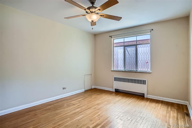 1523 Ivy St Unit 6, Denver, CO 80220 - unfurnished room with radiator heating unit, wood-type flooring, and ceiling fan