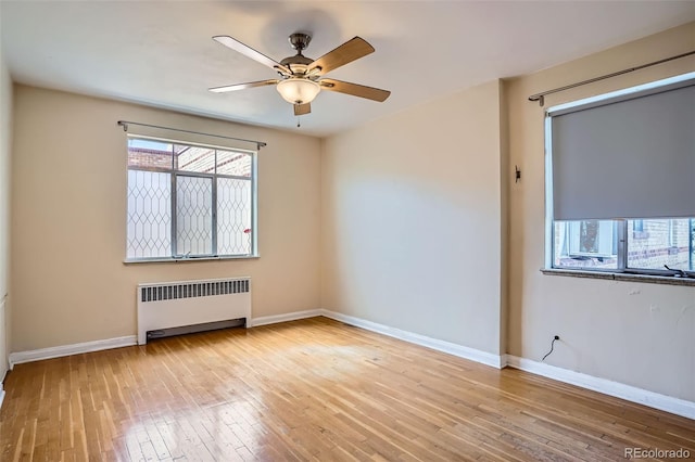 1523 Ivy St Unit 6, Denver, CO 80220 - empty room with radiator, hardwood / wood-style flooring, and ceiling fan