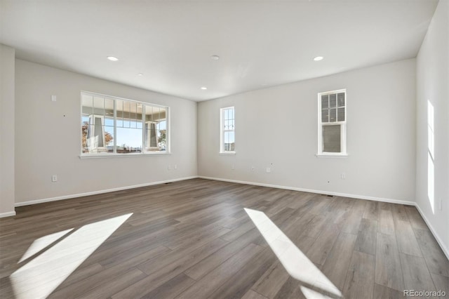 spare room with dark hardwood / wood-style floors