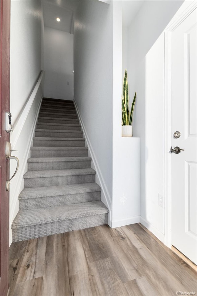 staircase featuring hardwood / wood-style floors