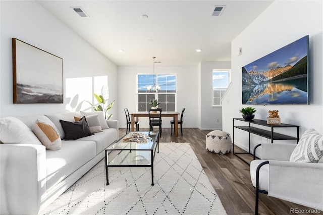 living room with hardwood / wood-style flooring and an inviting chandelier