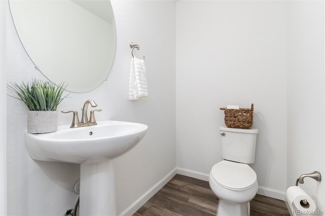 bathroom with sink, hardwood / wood-style flooring, and toilet