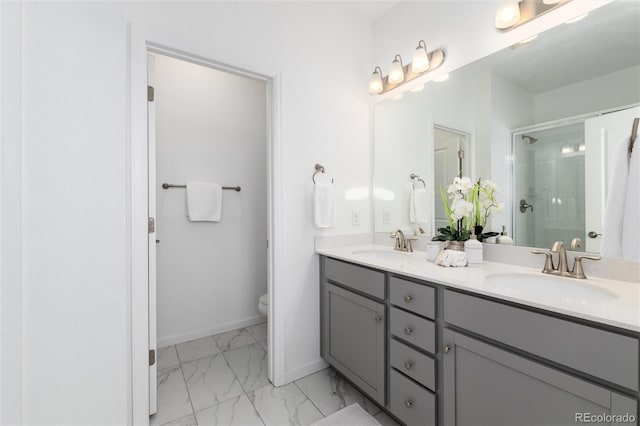 bathroom with vanity, toilet, and a shower with door