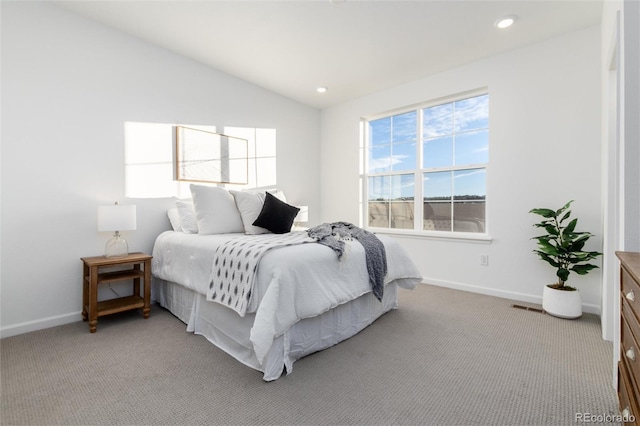 bedroom with vaulted ceiling and light carpet