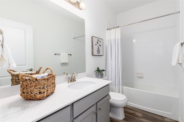 full bathroom featuring shower / bath combo, hardwood / wood-style floors, vanity, and toilet