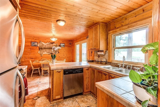 5030 Cedar Way, Elizabeth, CO 80107 - kitchen with stainless steel appliances, a peninsula, brown cabinets, wood ceiling, and a sink