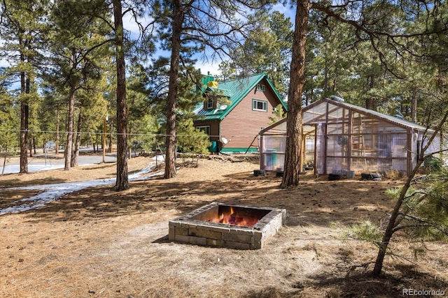5030 Cedar Way, Elizabeth, CO 80107 - view of yard featuring an exterior structure, an outdoor structure, and a fire pit