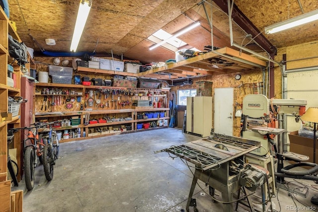 5030 Cedar Way, Elizabeth, CO 80107 - garage featuring a workshop area and freestanding refrigerator