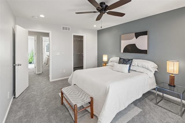 carpeted bedroom featuring baseboards, visible vents, a ceiling fan, a spacious closet, and recessed lighting