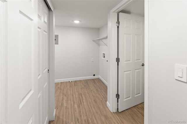 laundry room with laundry area, light wood-style flooring, hookup for a washing machine, and baseboards