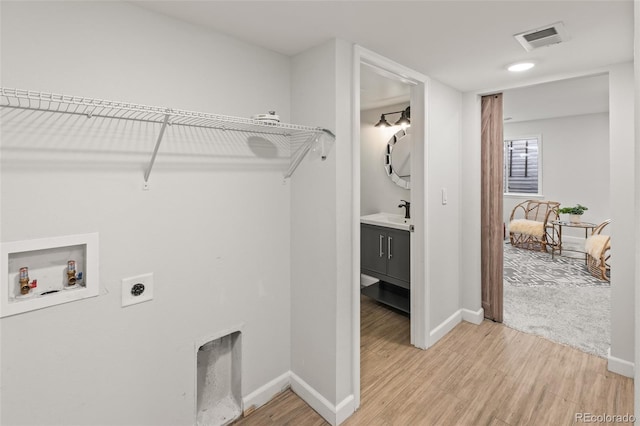 laundry room with laundry area, visible vents, hookup for a washing machine, light wood-style floors, and electric dryer hookup