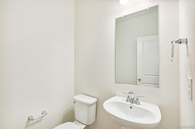 bathroom featuring a sink and toilet