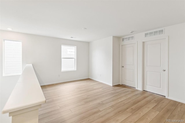 empty room featuring light wood-style flooring and baseboards