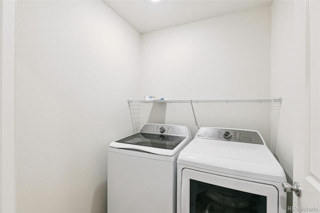 washroom with separate washer and dryer