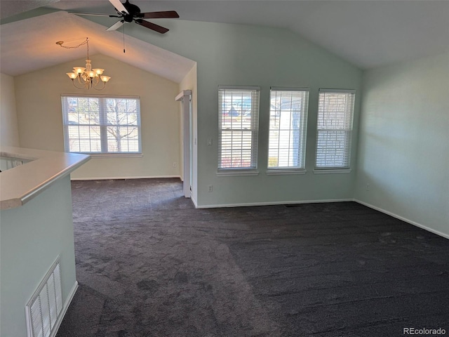 unfurnished living room with dark colored carpet, visible vents, vaulted ceiling, baseboards, and ceiling fan with notable chandelier