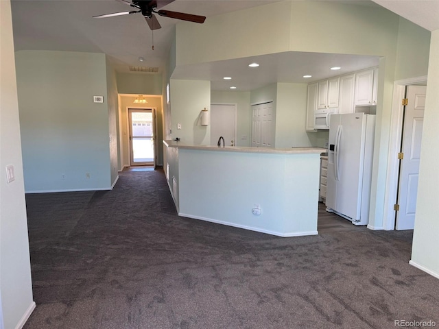 kitchen with recessed lighting, white appliances, white cabinets, light countertops, and dark carpet