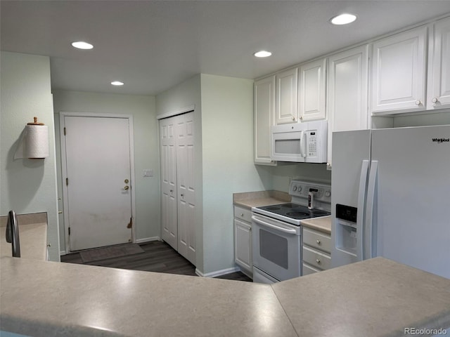 kitchen with recessed lighting, white appliances, white cabinets, and dark wood-style flooring