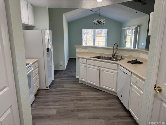 kitchen with light countertops, white appliances, and white cabinets