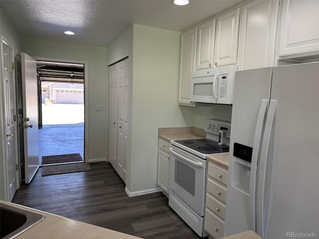 kitchen with white appliances, dark wood-style flooring, light countertops, a textured ceiling, and white cabinetry